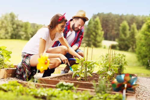 Front view of a gardener inspecting a client garden